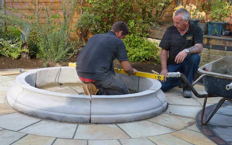 A team working on paving in a garden